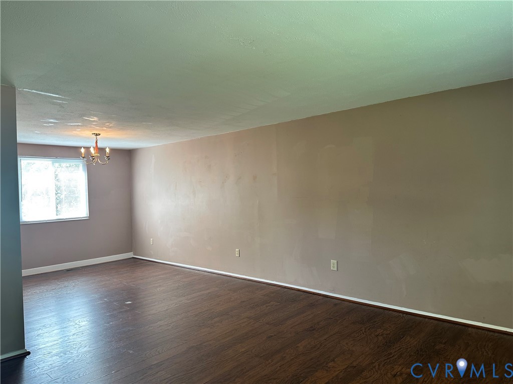 9319 Coleson Road Glen Allen, VA 23060 - Photo 22 of 39 an empty room with wooden floor and windows