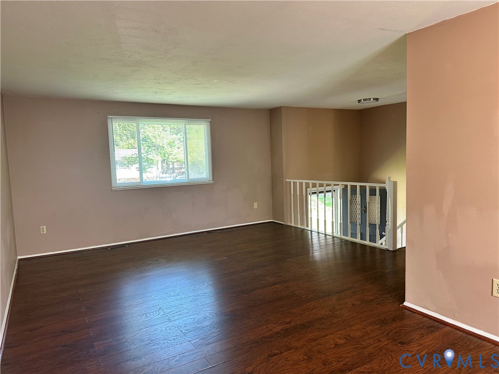9319 Coleson Road Glen Allen, VA 23060 - Photo 23 of 39 a view of an empty room with wooden floor and a window