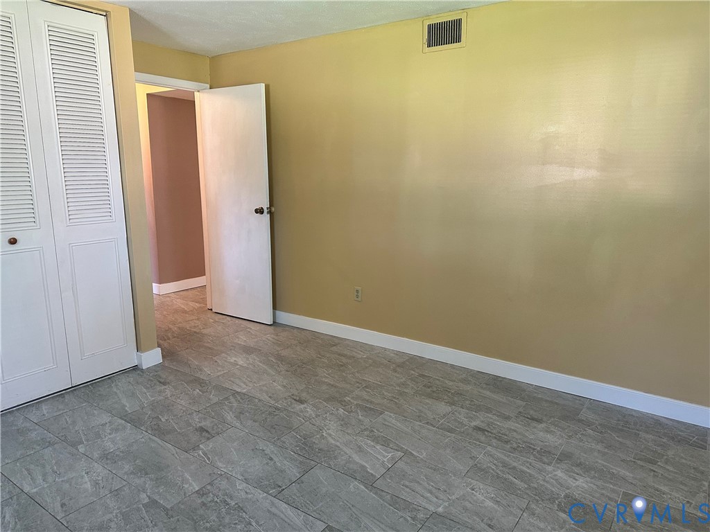 9319 Coleson Road Glen Allen, VA 23060 - Photo 26 of 39 an empty room with a wooden door