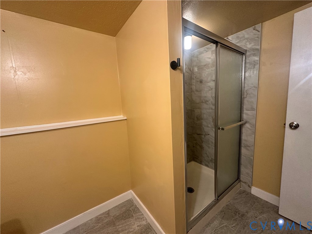 9319 Coleson Road Glen Allen, VA 23060 - Photo 30 of 39 a bathroom with a glass shower door