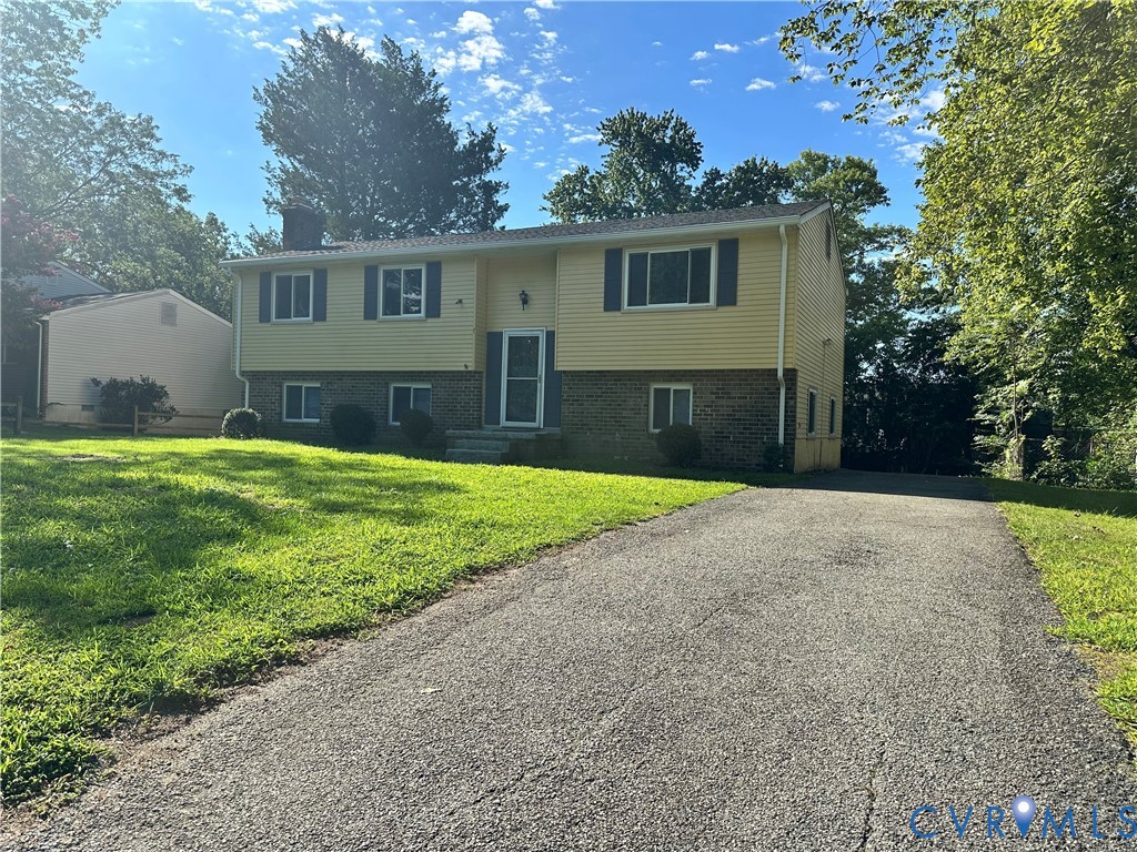 9319 Coleson Road Glen Allen, VA 23060 - Photo 3 of 39 a view of a house with a yard and garage