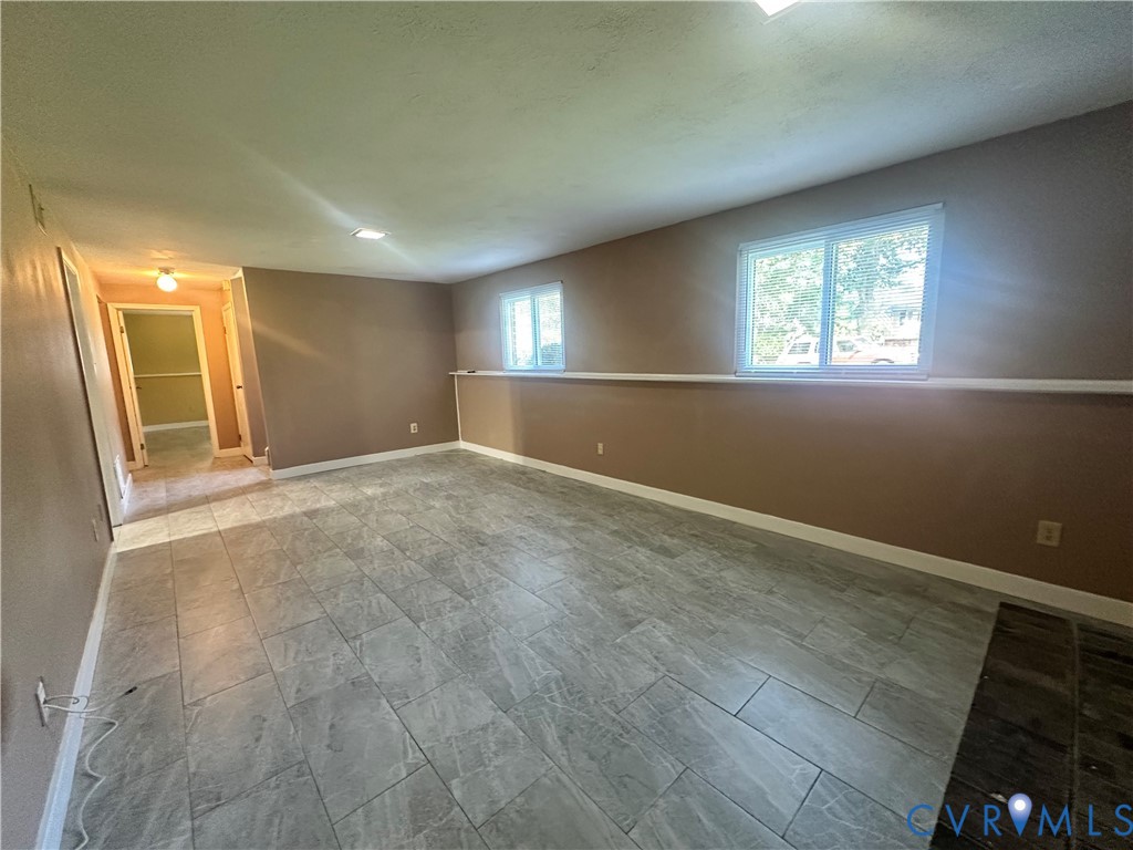 9319 Coleson Road Glen Allen, VA 23060 - Photo 33 of 39 an empty room with wooden floor and windows