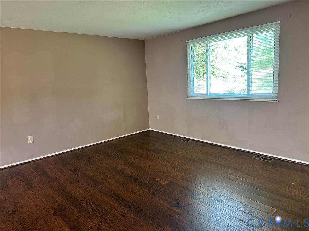 9319 Coleson Road Glen Allen, VA 23060 - Photo 6 of 39 a view of an empty room with wooden floor and a window