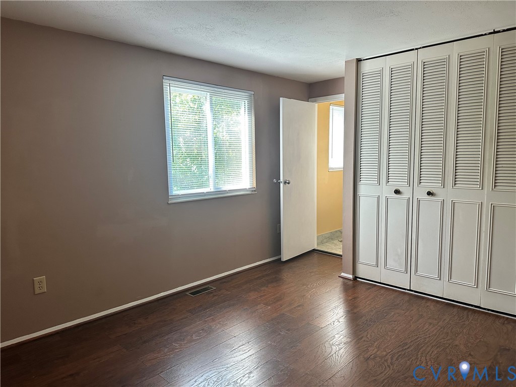 9319 Coleson Road Glen Allen, VA 23060 - Photo 10 of 39 an empty room with wooden floor and windows
