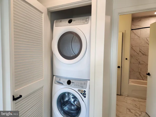a view of a hallway with washer and dryer