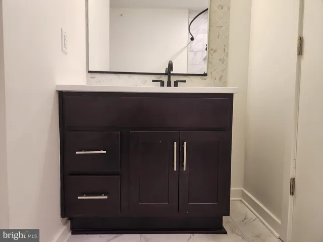 a bathroom with a sink and mirror