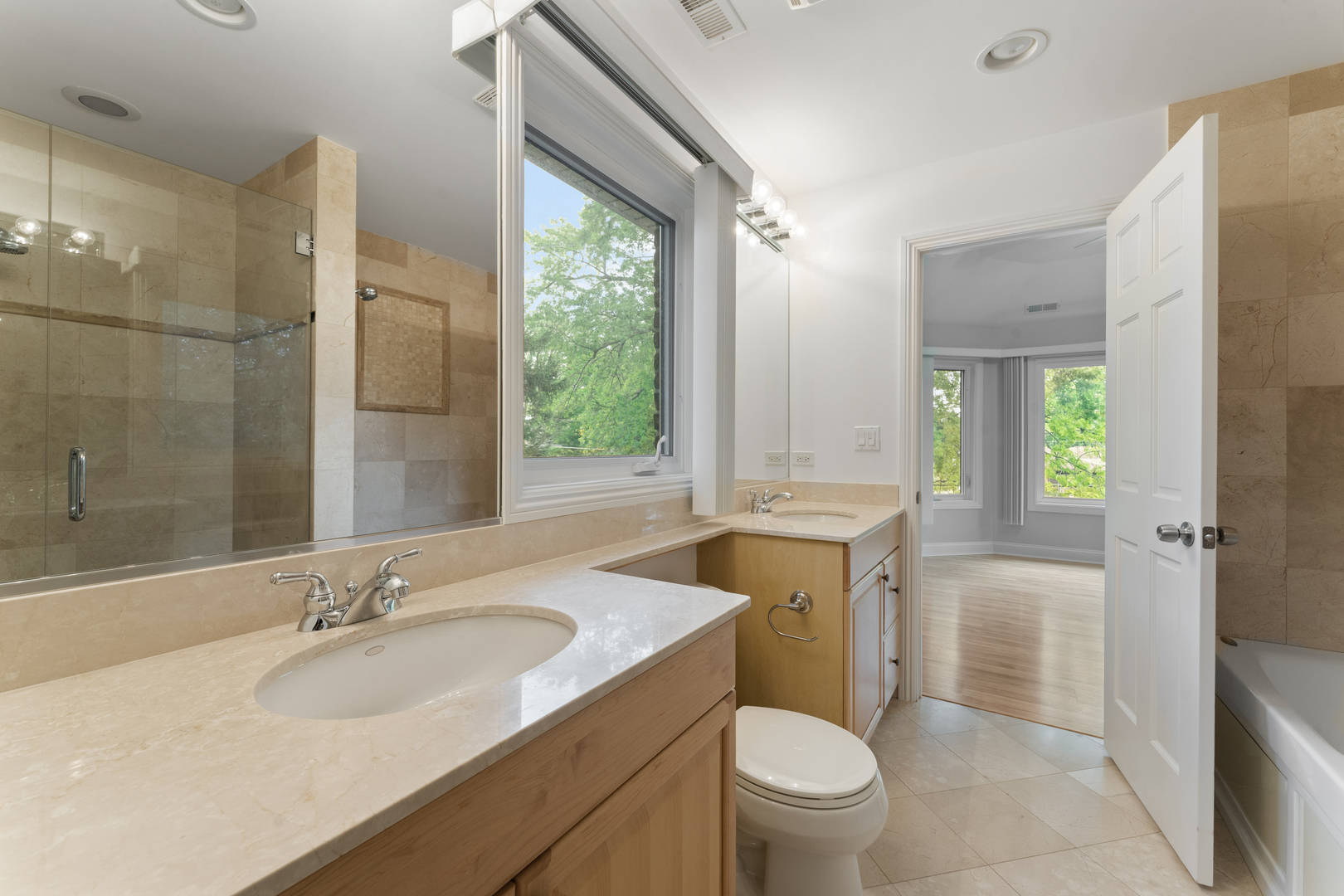 1184 Prospect Lane Des Plaines, IL 60018 - Photo 18 of 24 a bathroom with a granite countertop sink toilet and shower
