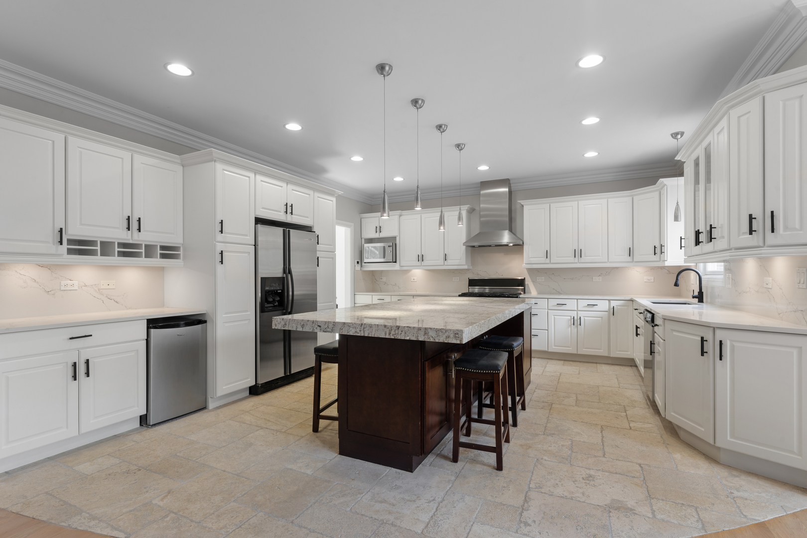 1184 Prospect Lane Des Plaines, IL 60018 - Photo 3 of 24 a kitchen with kitchen island granite countertop wooden cabinets a center island and stainless steel appliances