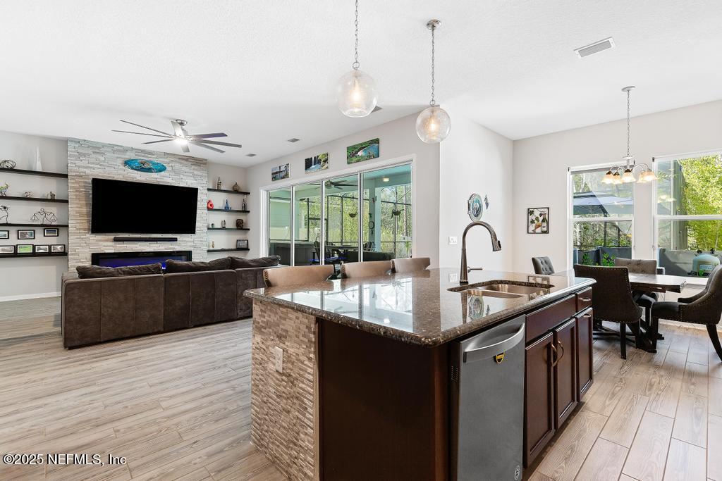 201 Oak Shadow Place St. Johns, FL 32259 - Photo 19 of 52 a kitchen with stainless steel appliances granite countertop a stove and a wooden floors