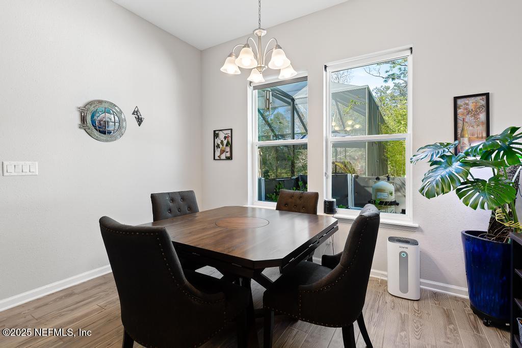 201 Oak Shadow Place St. Johns, FL 32259 - Photo 20 of 52 a view of a dining room with furniture window and wooden floor