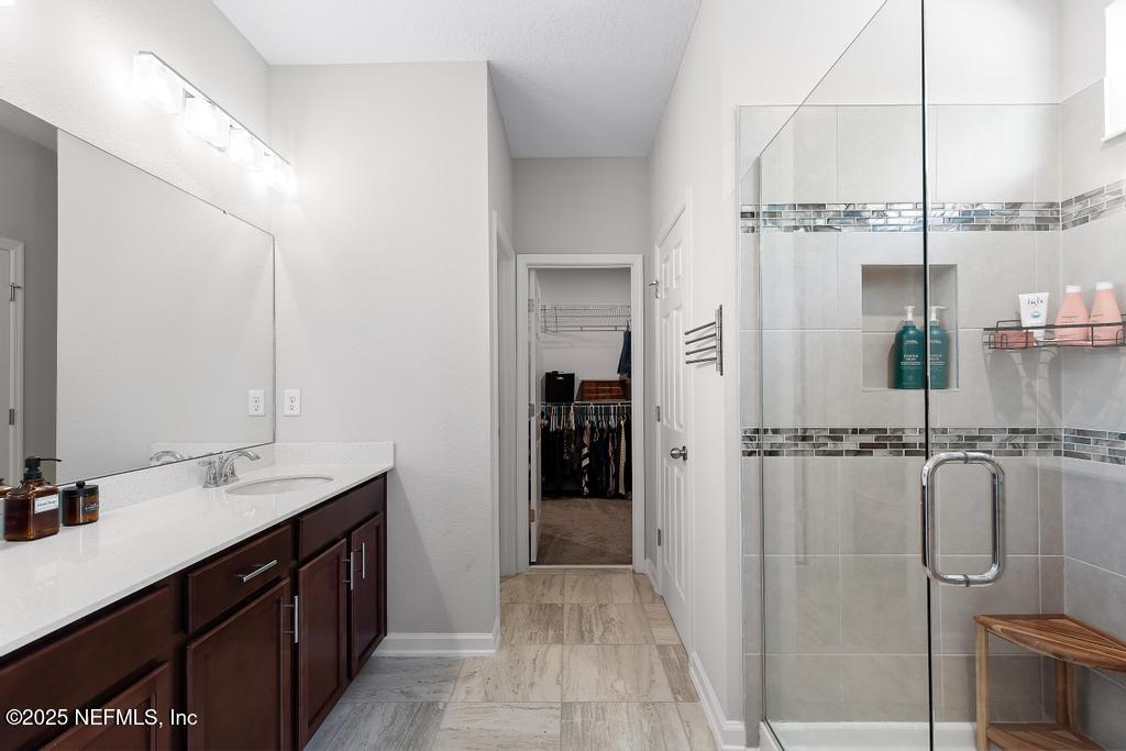 201 Oak Shadow Place St. Johns, FL 32259 - Photo 23 of 52 a bathroom with a double vanity sink a toilet and shower