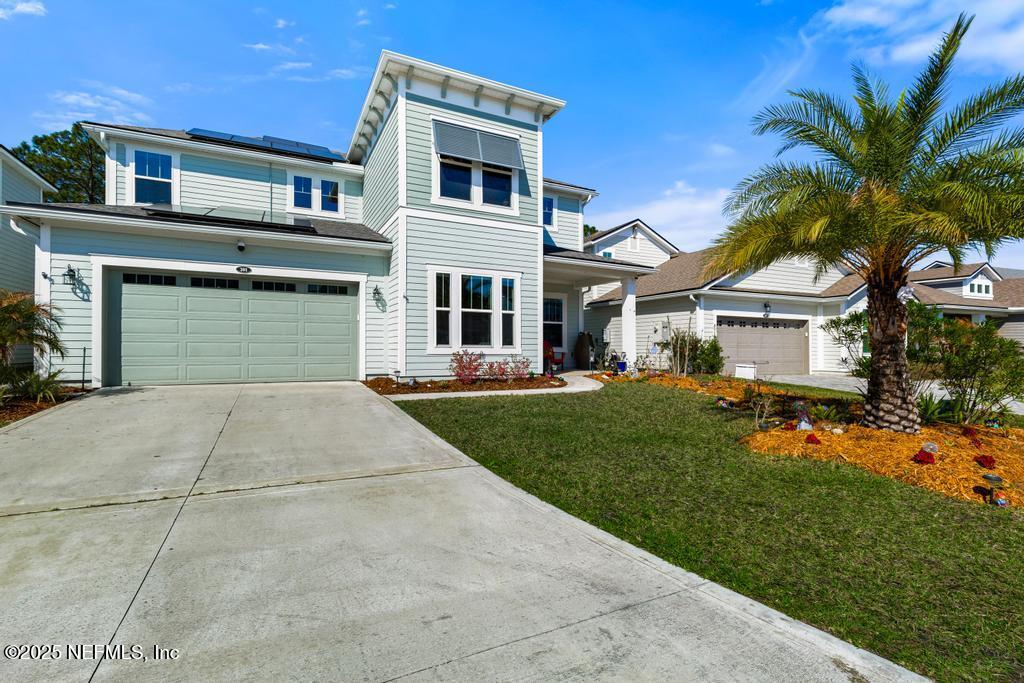 201 Oak Shadow Place St. Johns, FL 32259 - Photo 3 of 52 a front view of a house with a yard and garage