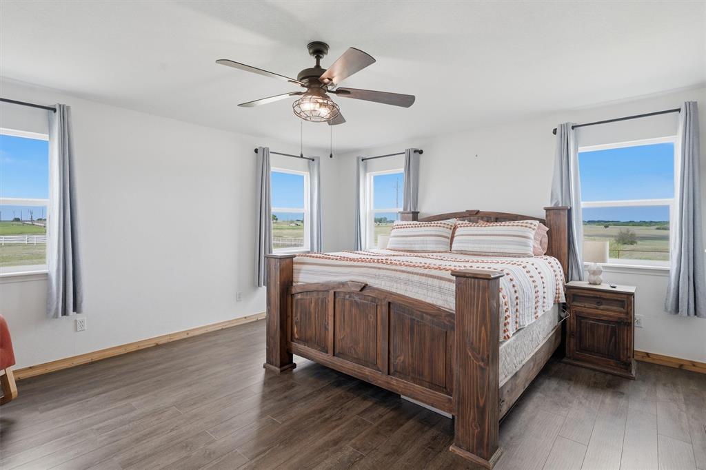 1051 Pigg Road Waxahachie, TX 75165 - Photo 14 of 40 a bedroom with a bed and a chandelier