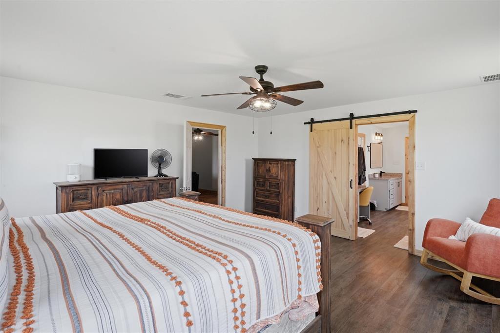 1051 Pigg Road Waxahachie, TX 75165 - Photo 16 of 40 a bedroom with a bed and a television