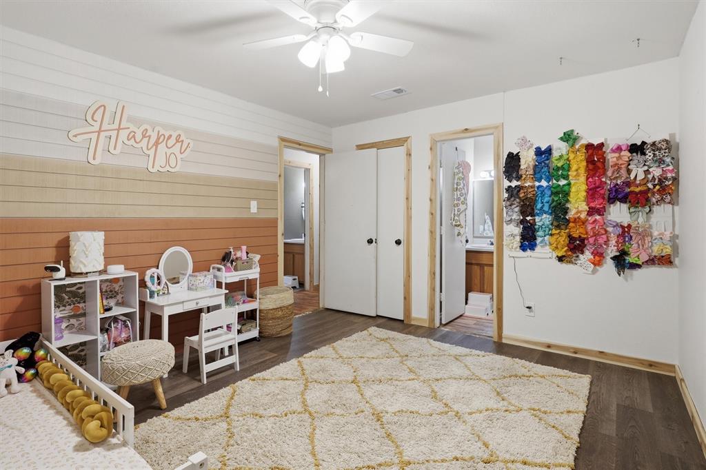 1051 Pigg Road Waxahachie, TX 75165 - Photo 18 of 40 a bed room with a bed and a chandelier