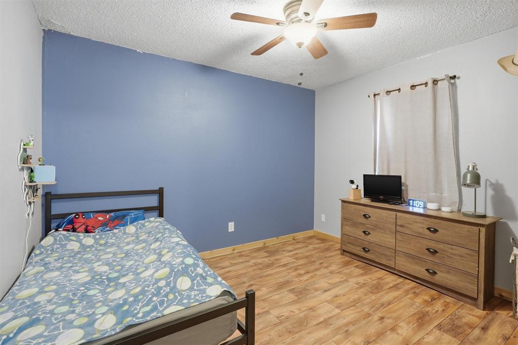 1051 Pigg Road Waxahachie, TX 75165 - Photo 19 of 40 a bedroom with a bed and a dresser