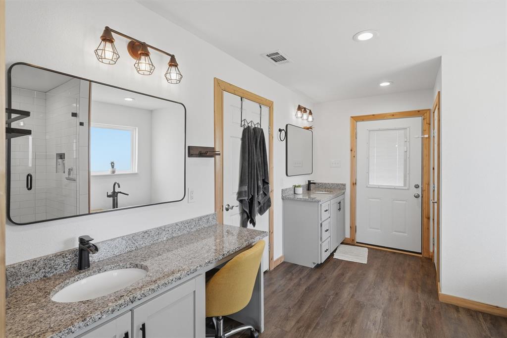 1051 Pigg Road Waxahachie, TX 75165 - Photo 22 of 40 a bathroom with a granite countertop sink mirror and toilet