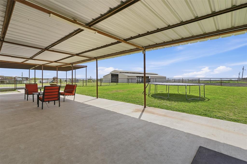 1051 Pigg Road Waxahachie, TX 75165 - Photo 32 of 40 a view of a backyard with table and chairs