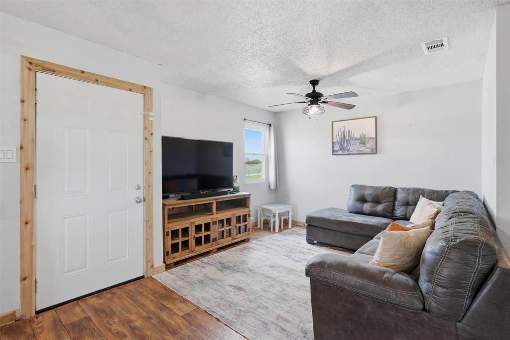 1051 Pigg Road Waxahachie, TX 75165 - Photo 6 of 40 a living room with furniture and a flat screen tv