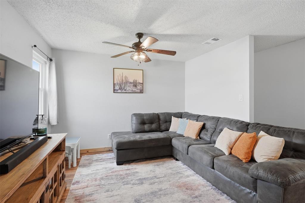 1051 Pigg Road Waxahachie, TX 75165 - Photo 7 of 40 a living room with furniture and a flat screen tv