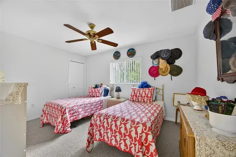 a bedroom with two beds and a chandelier