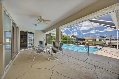 a view of a patio with table and chairs