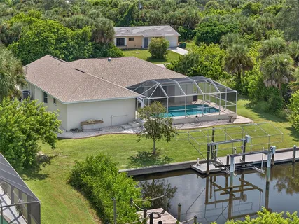 a view of a patio with table and chairs under an umbrella