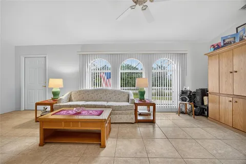 a bedroom with furniture and a large window