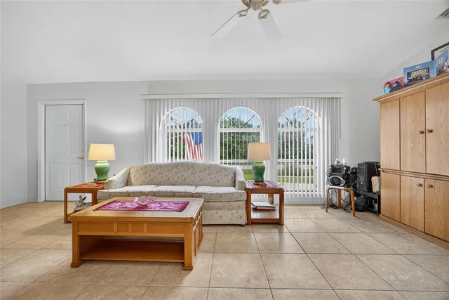a bedroom with furniture and a large window