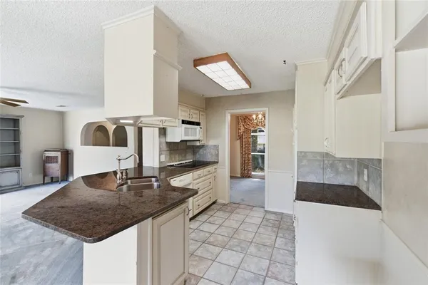 a kitchen with stainless steel appliances a sink stove and cabinets