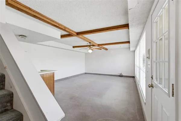 a view of a porch with wooden floor and a ceiling fan