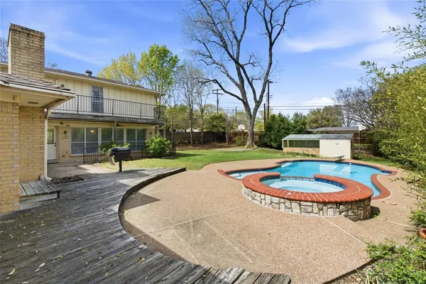 a view of a swimming pool with a patio