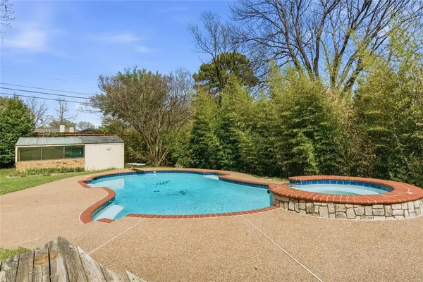 a view of a house with swimming pool and yard