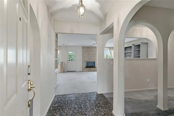 an empty room with furniture and a fireplace