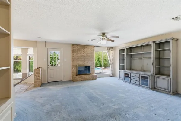 a view of a kitchen with a sink and a refrigerator
