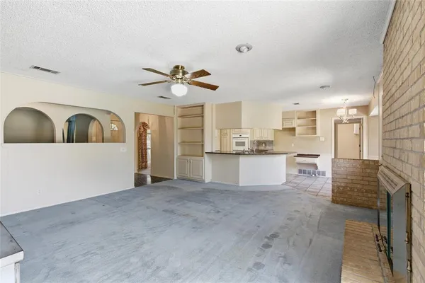 a kitchen with granite countertop a sink and a stove top oven