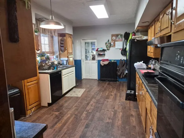a kitchen with a refrigerator and a stove