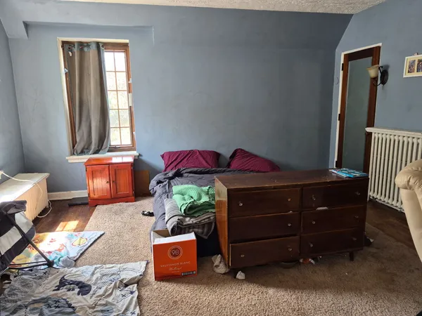 a bedroom with a bed and a window