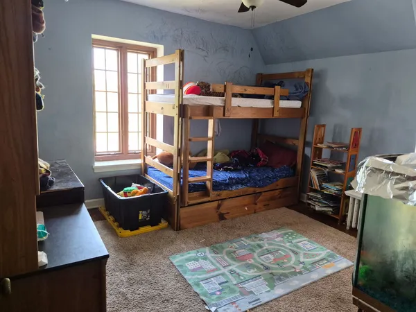 a bed room with a bed and a window