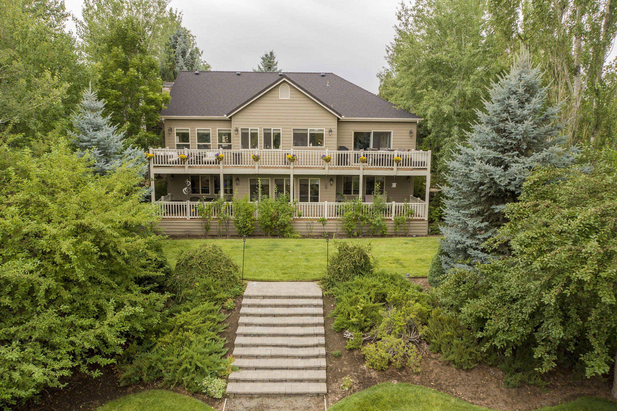 61538 Southeast Hill Ridge Road Bend, OR 97702 - Photo 1 of 59 a front view of a house with a yard and green space
