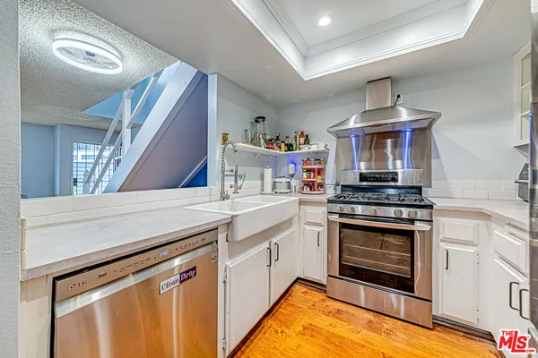 a kitchen with stainless steel appliances granite countertop a stove and a sink