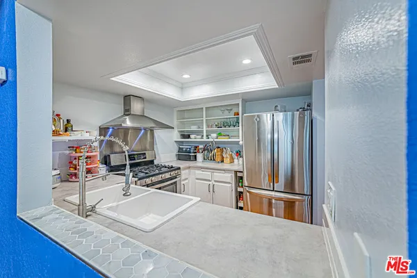 a room with furniture and a kitchen view