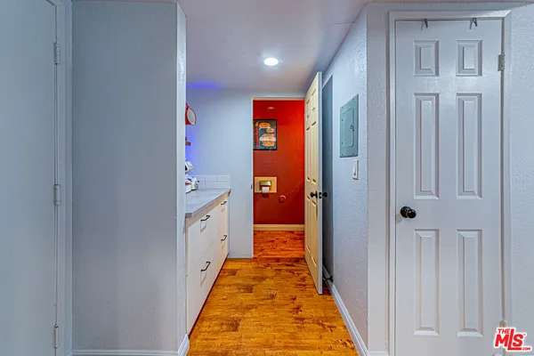 a hallway with white cabinets