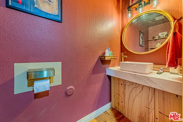a bathroom with a sink a mirror and a vanity
