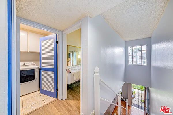 a view of a hallway and a livingroom with wooden floor