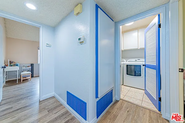 a view of a room with wooden floor and furniture