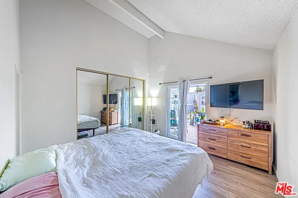 a bedroom with a bed and a dresser in it