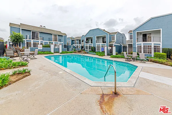 a house view with a swimming pool and glass windows