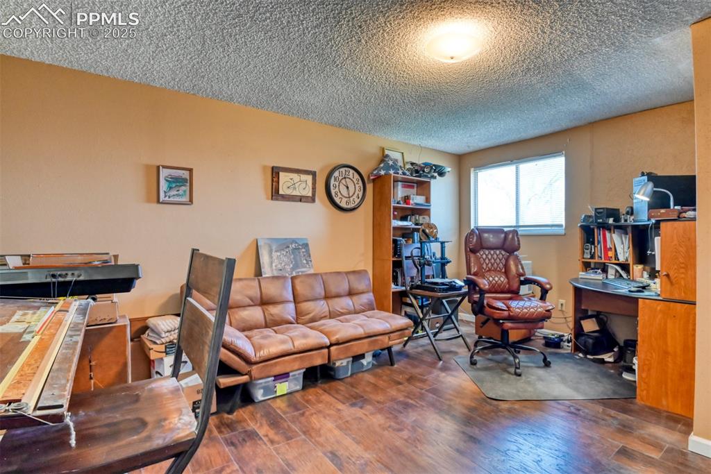 10970 Garrett Road Peyton, CO 80831 - Photo 22 of 50 a living room with furniture and a wooden floor