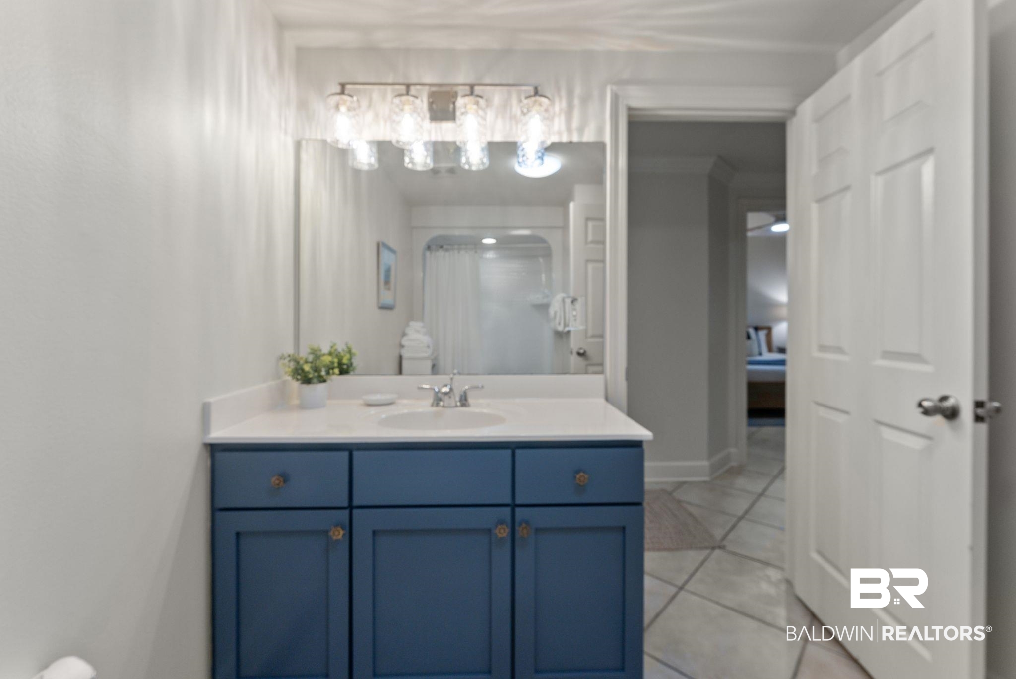 27580 Canal Road, Unit 1233 Orange Beach, AL 36561 - Photo 11 of 79 Bathroom featuring vanity, a shower with shower curtain, and light tile patterned floors